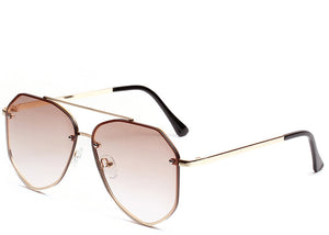 Women's brown tinted oversized aviator sunglasses with gold frame