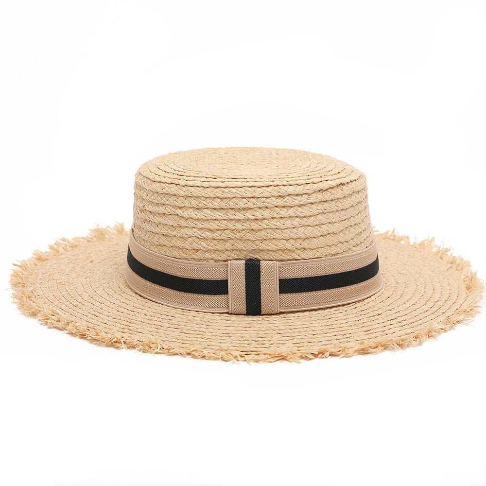 Women's boater straw hat with frayed edging and black ribbon detail