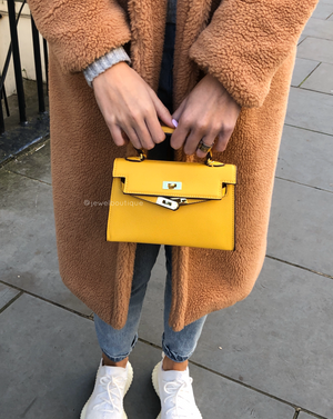 Women's yellow vegan faux leather mini handbag with gold hardware