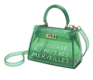 Women's semi transparent green handbag with graffiti writing and gold hardware 